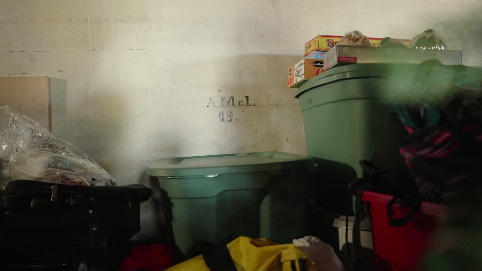 Old handwriting on the attic wall reading A. McL 09