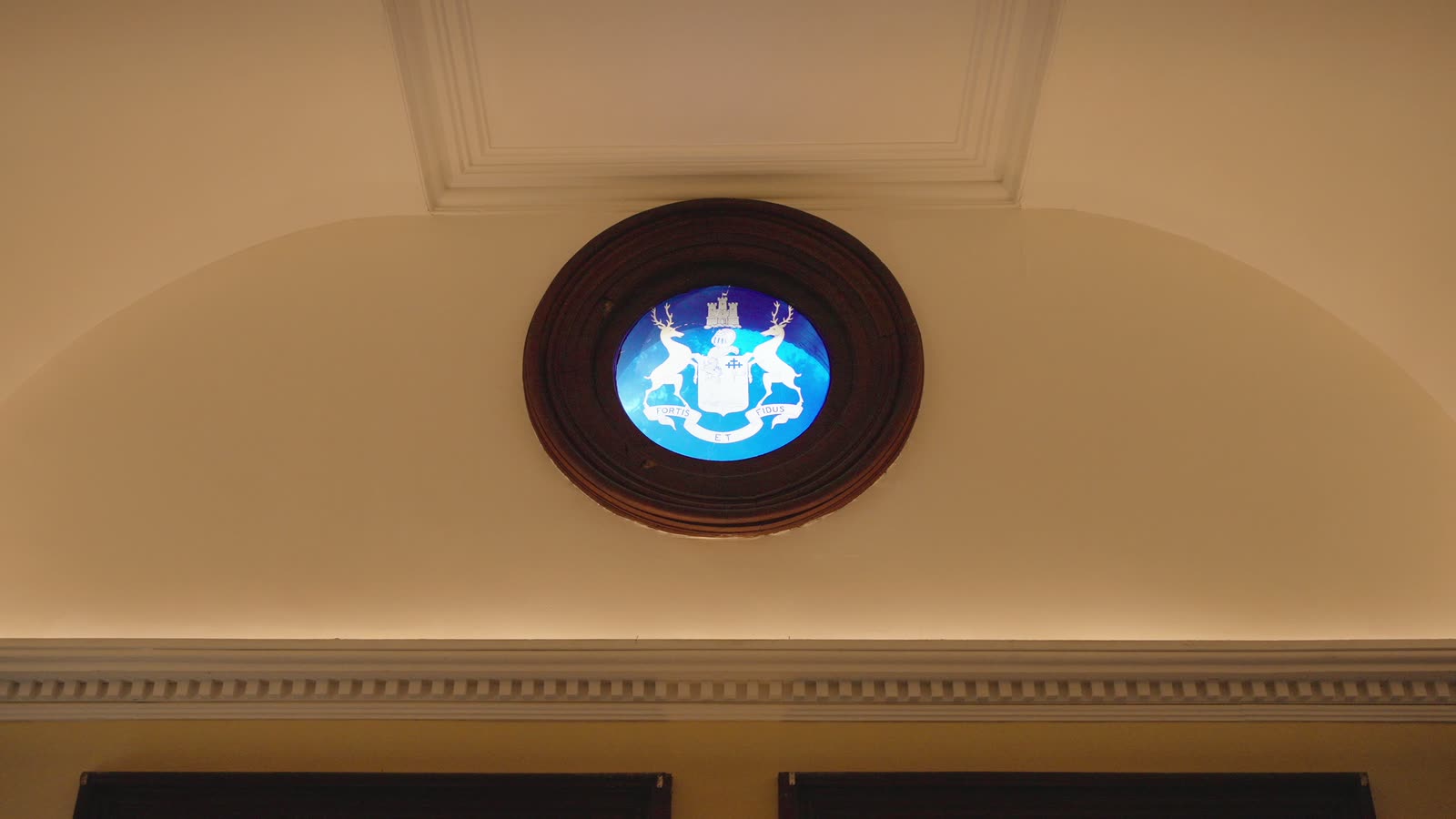 The McLachlin family crest in a round blue window high in the master bedroom